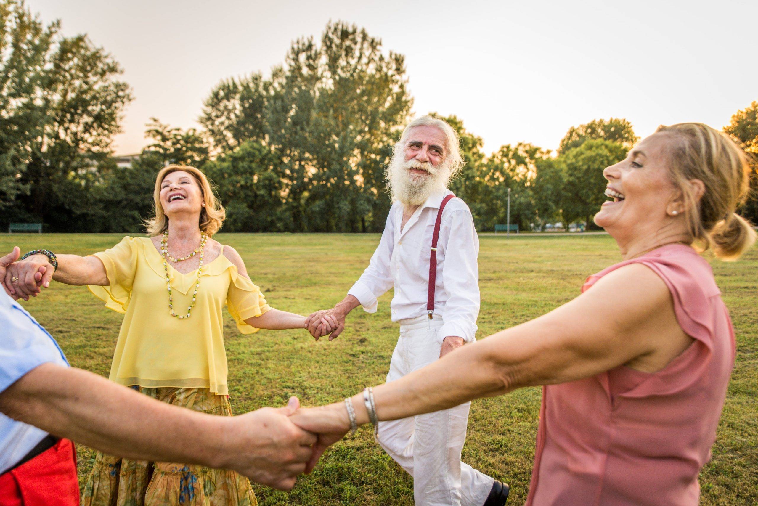 A diverse group of senior citizens holding hands, symbolizing unity and wellness while exploring the impact of free radicals and C60 benefits